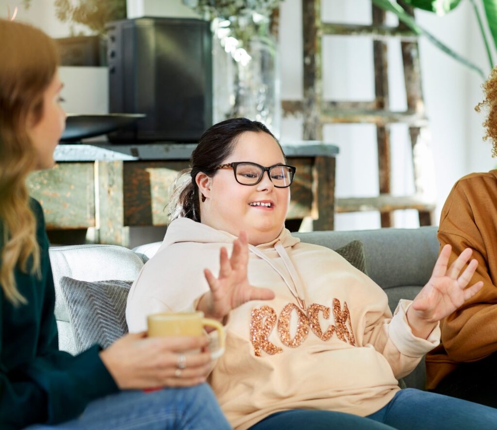 Three women sitting on a couch talking