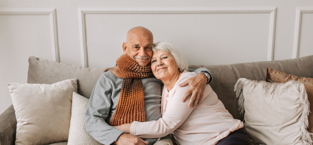Elderly man and woman sitting on a couch
